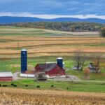 Idyllic farm scene with silo and barn in rural Pennsylvania fields.